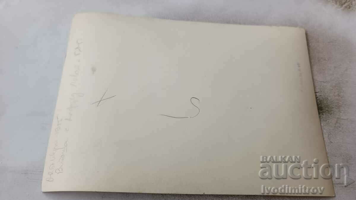 Photo Two men lighting cigarettes next to a vintage car 1955 with price 2.65 BGN | € 1.35 Photo Two men lighting cigarettes next to a vintage car 1955 with price 2.65 BGN | € 1.35