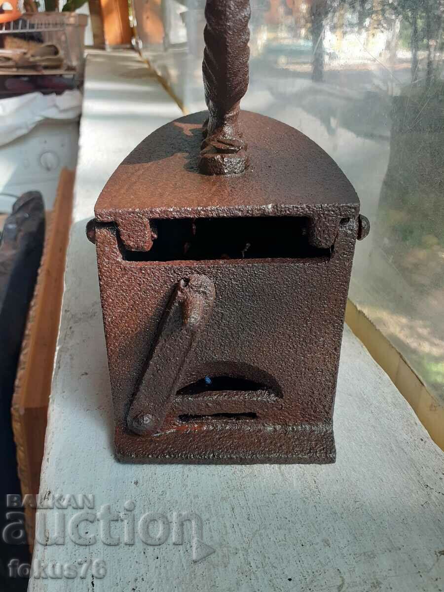Auction An old cast iron iron on fire Auction An old cast iron iron on fire