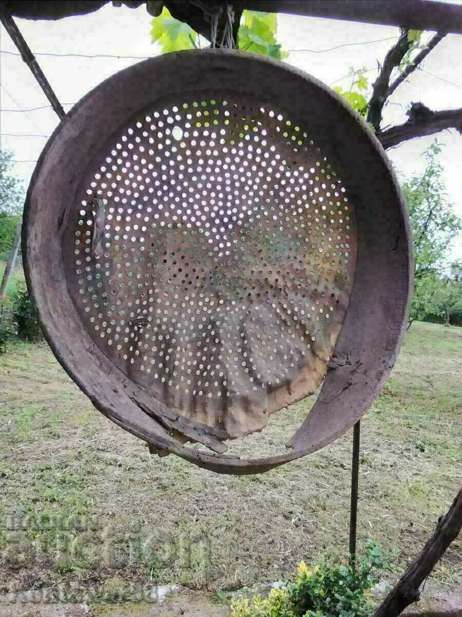 Antique wooden sieve with leather.