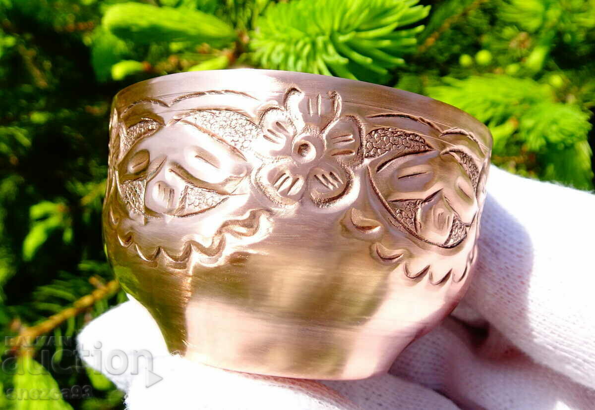 Copper cup with wrought ornaments.