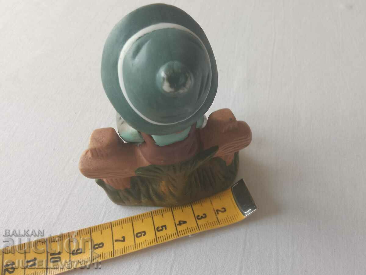 Auction Porcelain figure of a Dutch boy playing an accordion Auction Porcelain figure of a Dutch boy playing an accordion