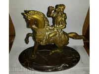Bronze horseman on marble