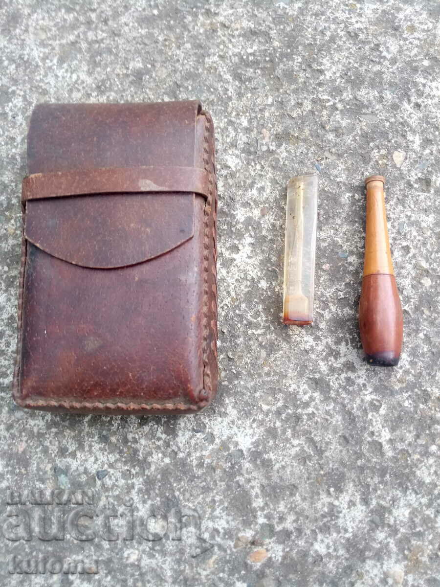 An old leather snuffbox and two cigarettes