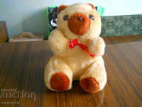 old plush children's toy with a mechanism - a bear