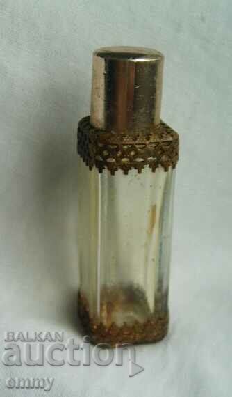 Old glass perfume bottle with ornaments