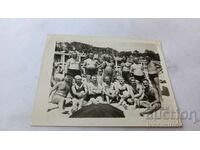 Photo Men and women in vintage swimsuits on the beach