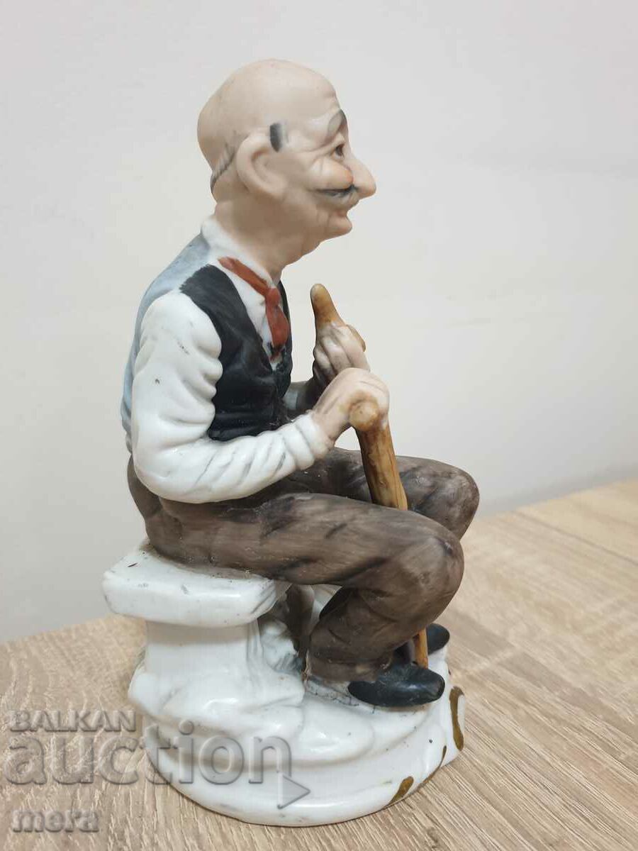 Auction Porcelain figure of an old man with a pipe Auction Porcelain figure of an old man with a pipe