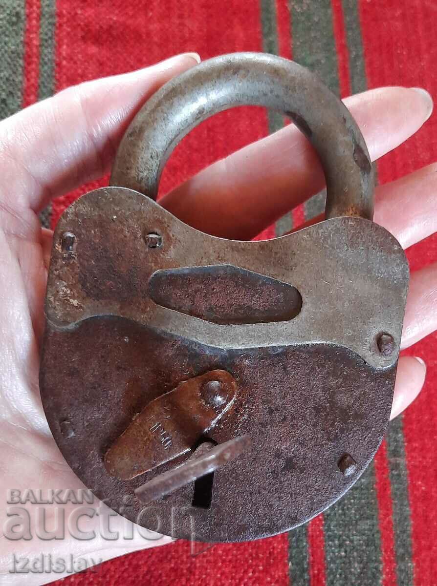 Old massive padlock with key, works