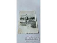 Photo Young man in a swimsuit at the pool
