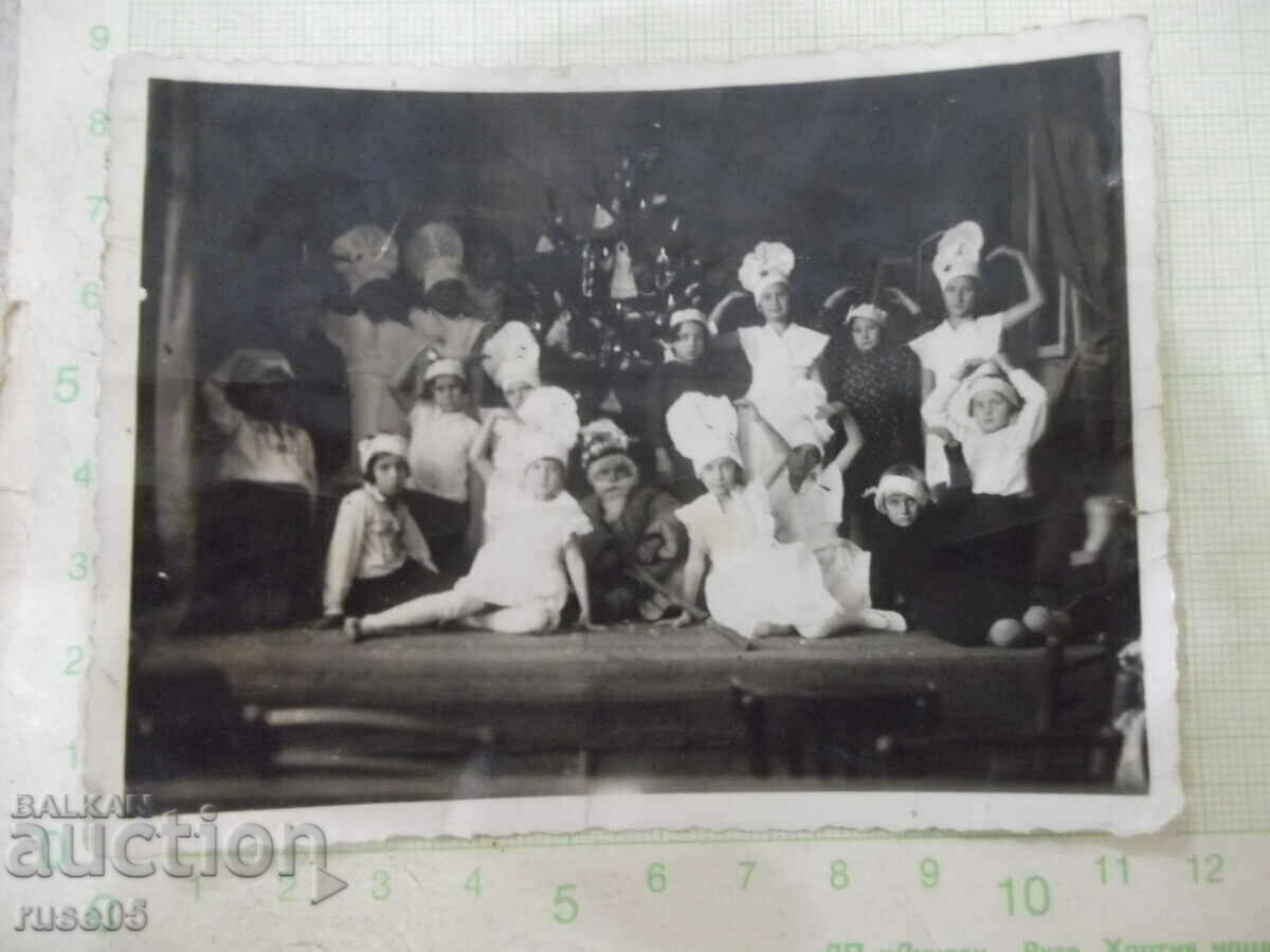 Old photo of children's snowflakes in front of the Christmas tree