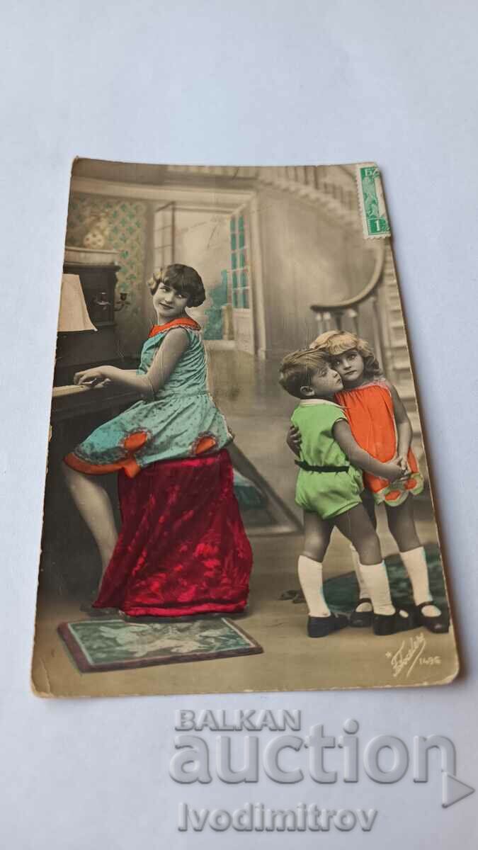 Postcard Boy and girl and woman playing the piano