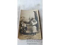 Postcard A woman with a milkmaid and two young girls