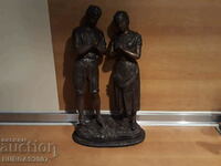 Old metal statuettes, man, woman, prayer