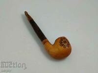 Old pyrographed wooden pipe