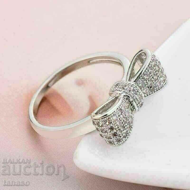 Auction Women's ring with white zircons - ribbon Auction Women's ring with white zircons - ribbon