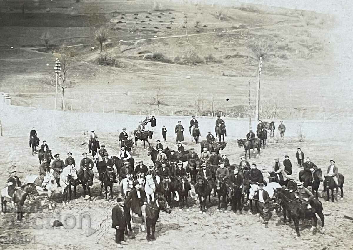 Photograph of a group of people on horses