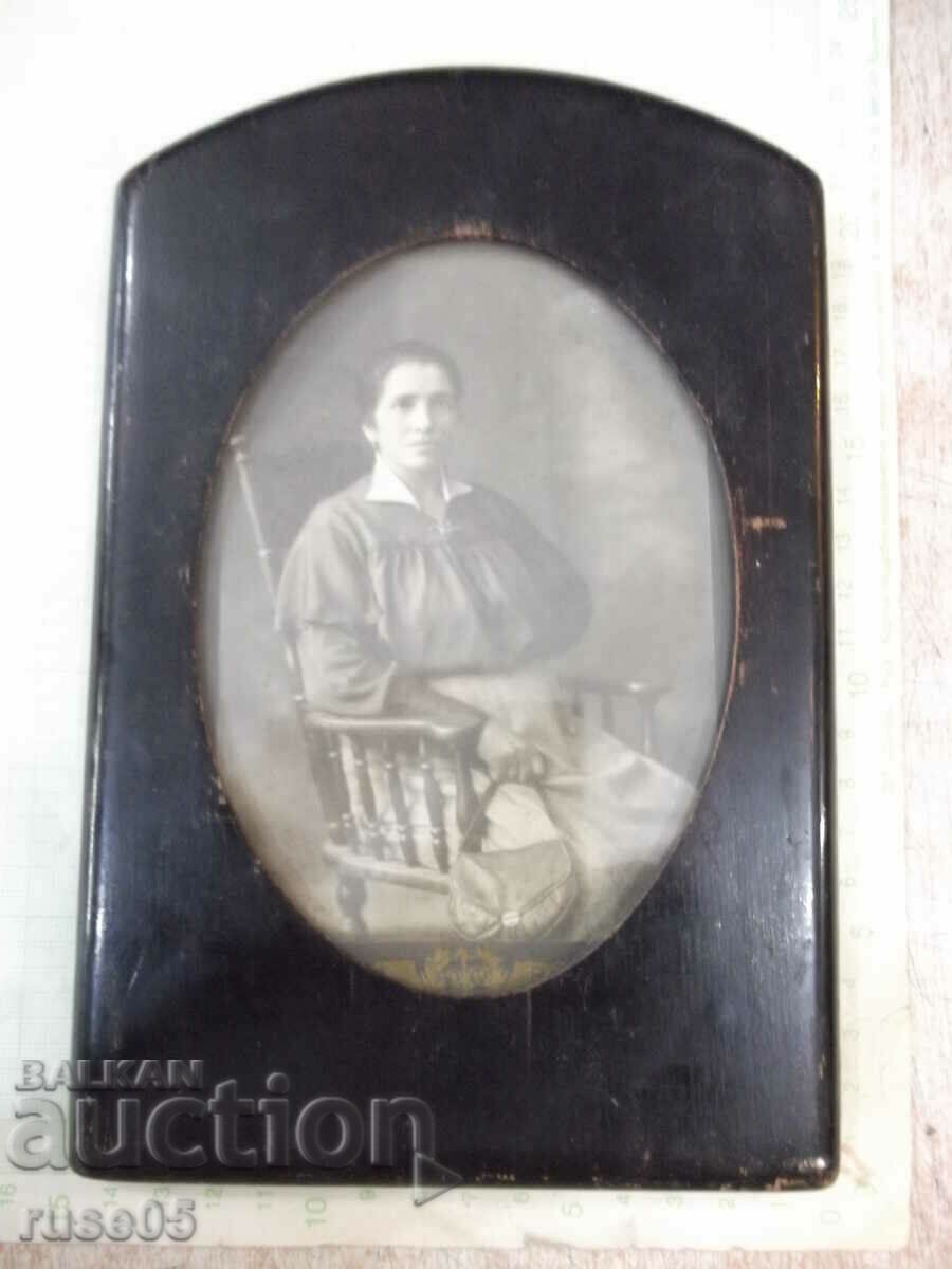 Old photo of a woman in a wooden frame