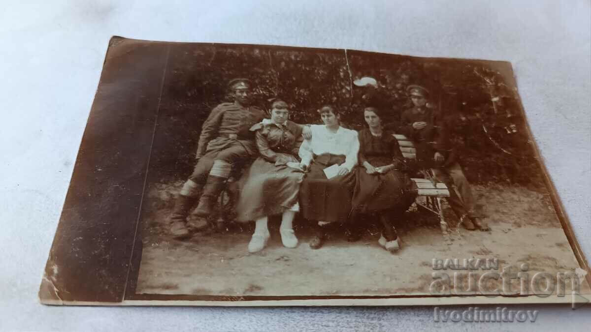 Photo Pleven Officer and three young girls on a park bench