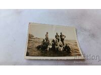 Photo Soldiers in swimsuits on a rock in the sea