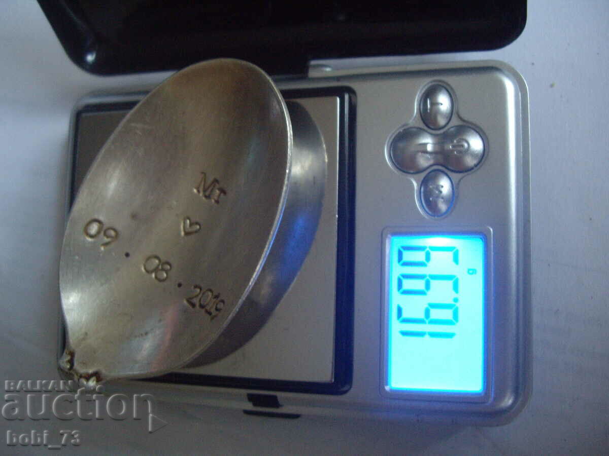 Auction  Part of a silver spoon.