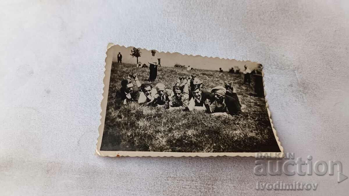 Photo Young people lying in the grass