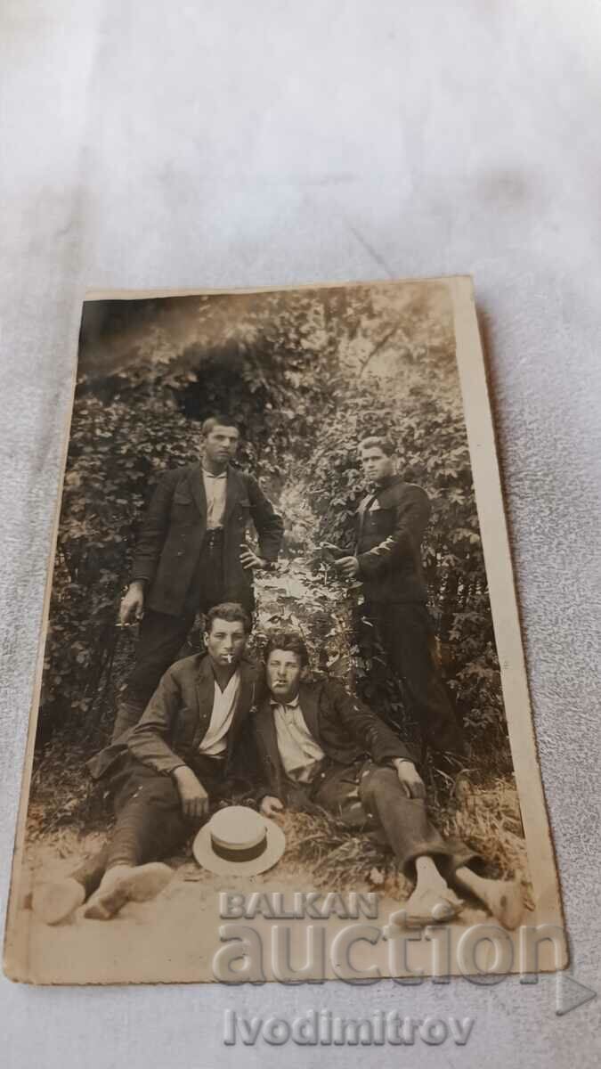 Photo Four young men in the forest