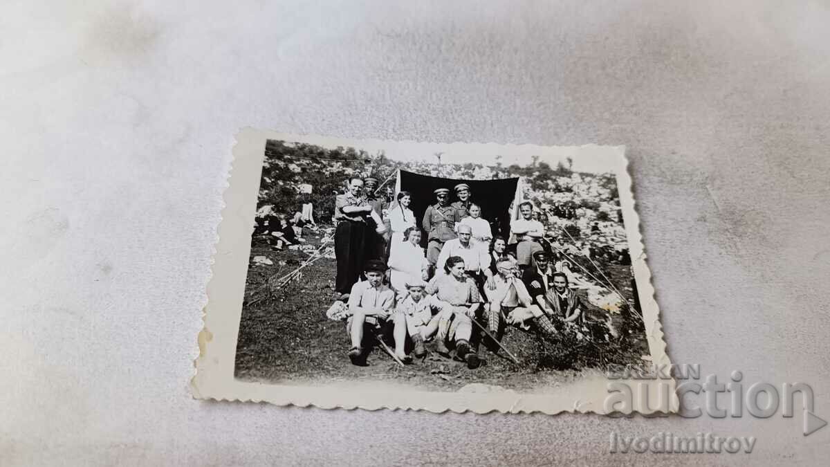 Photo Officers men women and children in front of a tent 1947