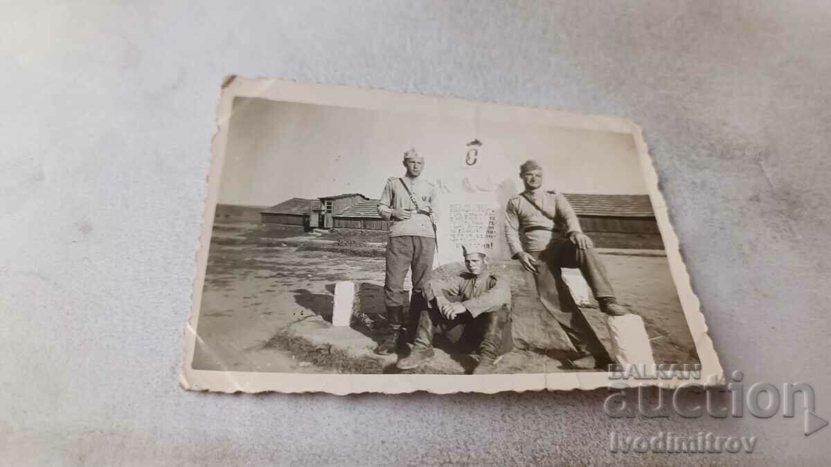 Foto Trei sergenți în fața unui memorial de război