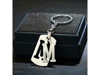 Metal plate with the letter " M " keychain