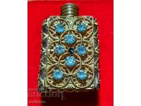 Openwork gilded perfume bottle