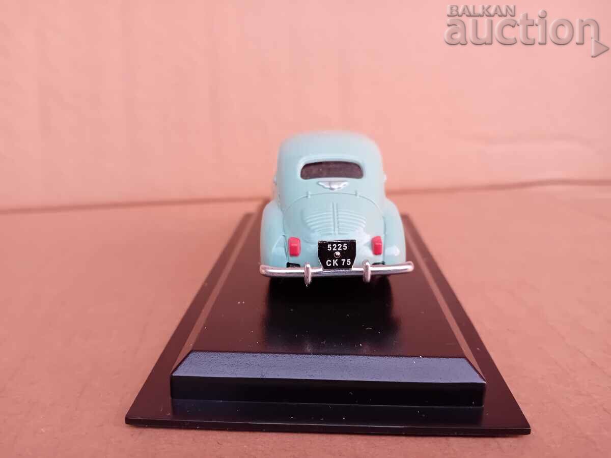 Delivery of Renault 4CV retro vintage metal toy on stand Delivery of Renault 4CV retro vintage metal toy on stand