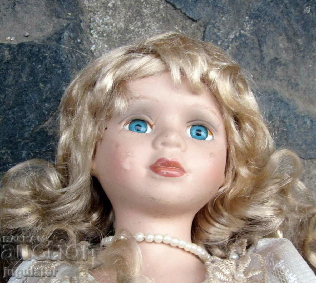 old porcelain doll with glass eyes marked with price 30.00 BGN | € 15.34