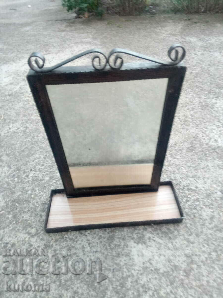 Old mirror with wrought iron frame
