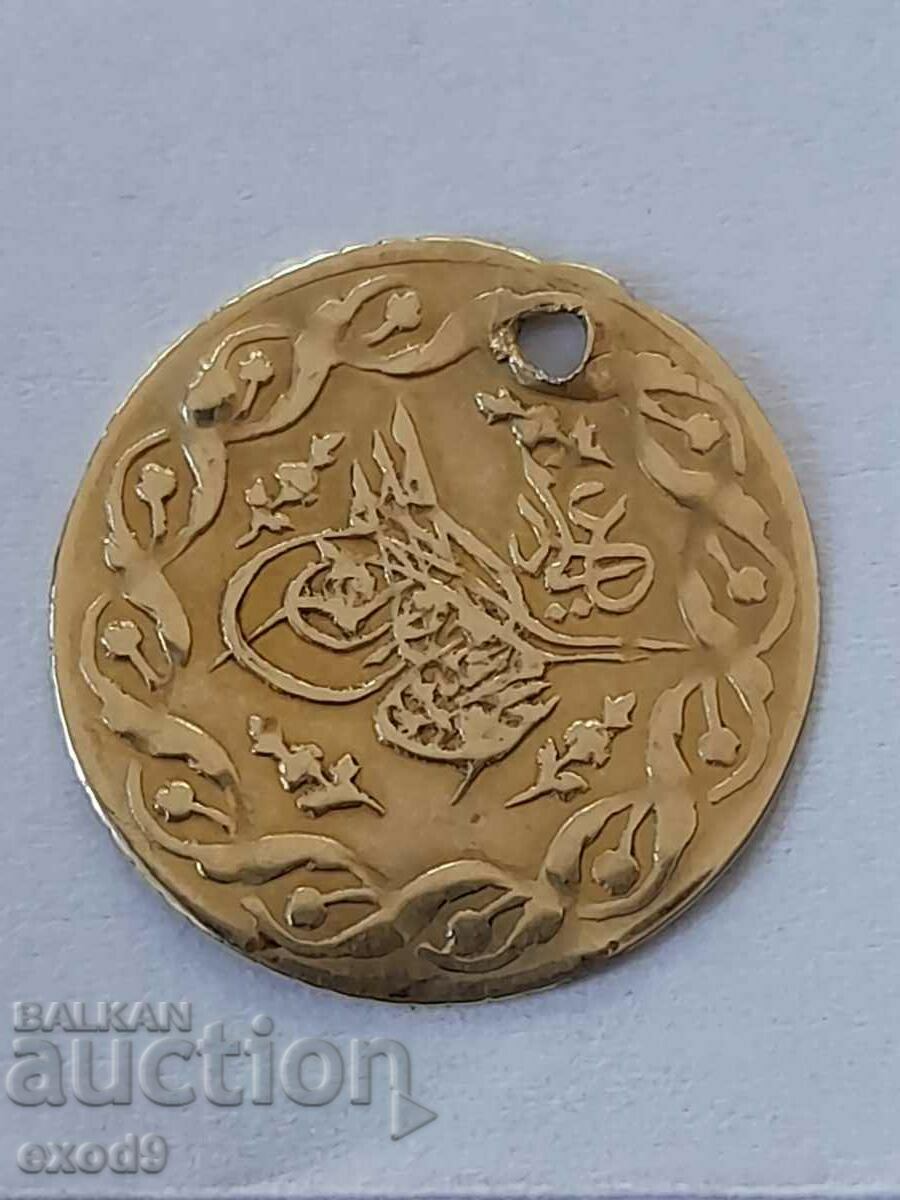 A rare gold coin, the pendara.