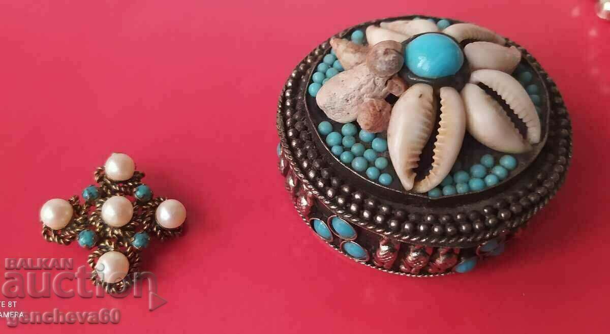 Old metal jewelry box and brooch