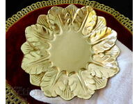 Bronze plate with embossed petals.