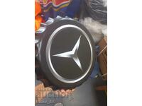 Metal plate in the shape of a Mercedes cap