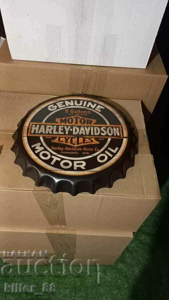 Metal sign in the shape of a Harley-Davidson cap