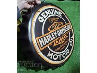 Metal sign in the shape of a Harley-Davidson cap