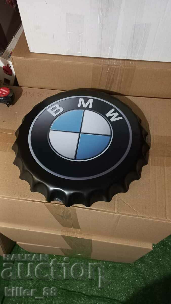 Metal plate in the shape of a BMW cap