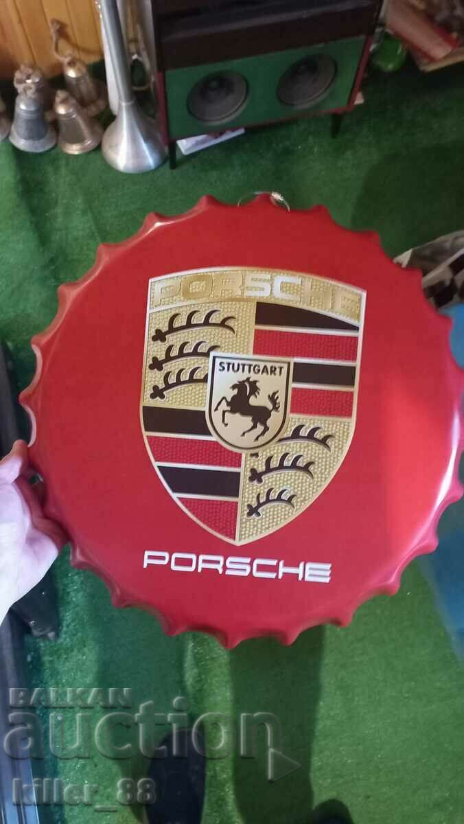 Metal plate in the shape of a Porsche cap