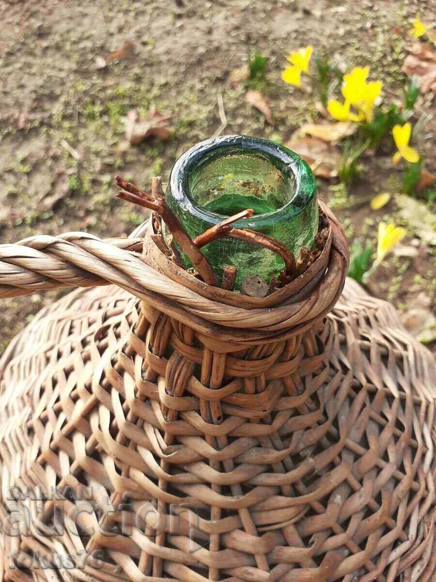 Auction Old glass damajana entwined with rattan Auction Old glass damajana entwined with rattan