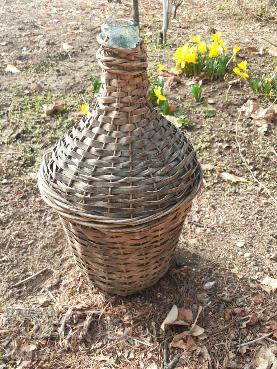 Auction Old glass damajana entwined with rattan Auction Old glass damajana entwined with rattan