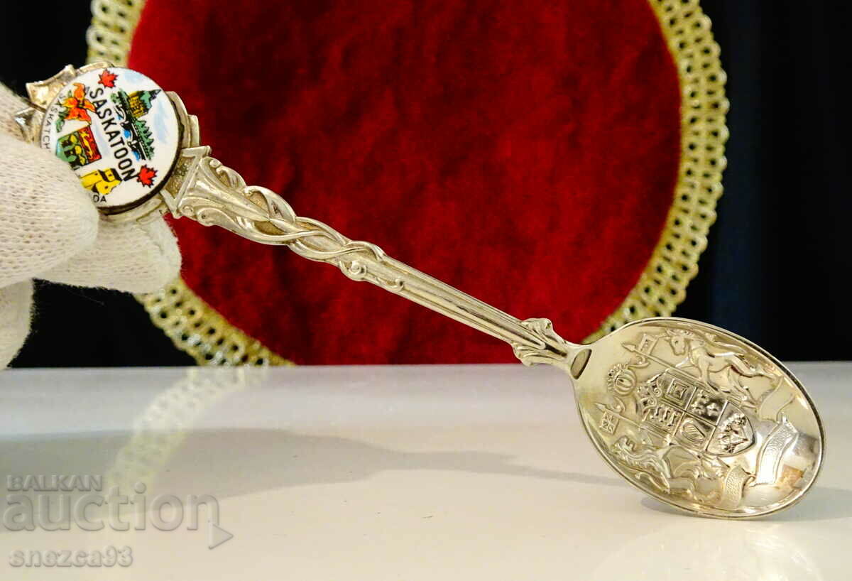 Silver plated spoon with embossed coat of arms.