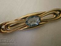 An old brooch - with a large blue gem - marked on and
