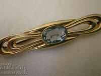 An old brooch - with a large blue gem - marked on and