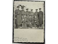 40 soldiers in front of a monument with an Eagle