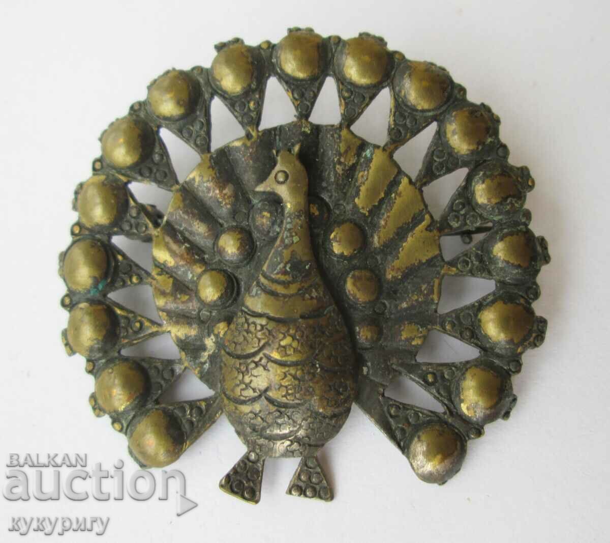 Old lady's brooch in the shape of a peacock