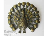 Old lady's brooch in the shape of a peacock
