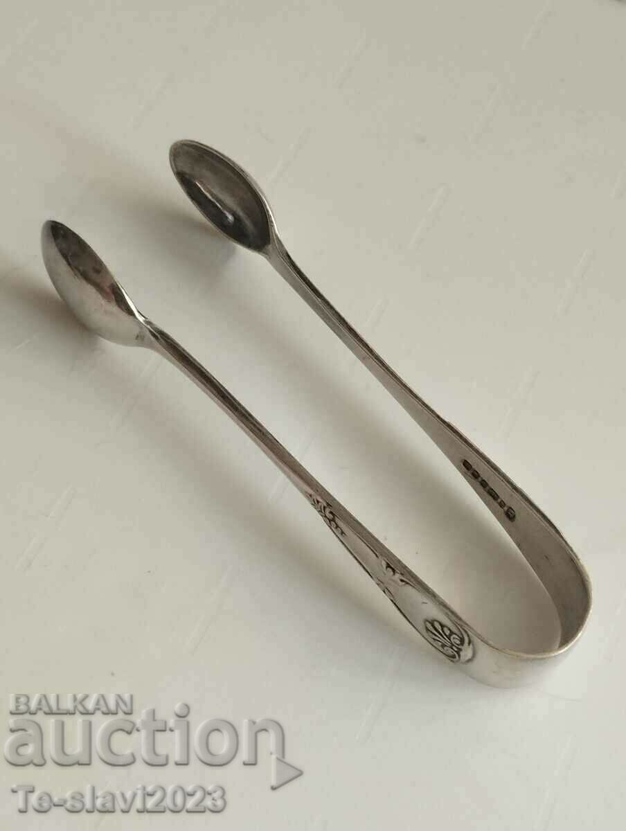 Old silver-plated sugar tongs, ice